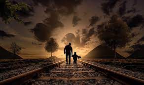 Faterh adn son walking railroad tracks to the horizon